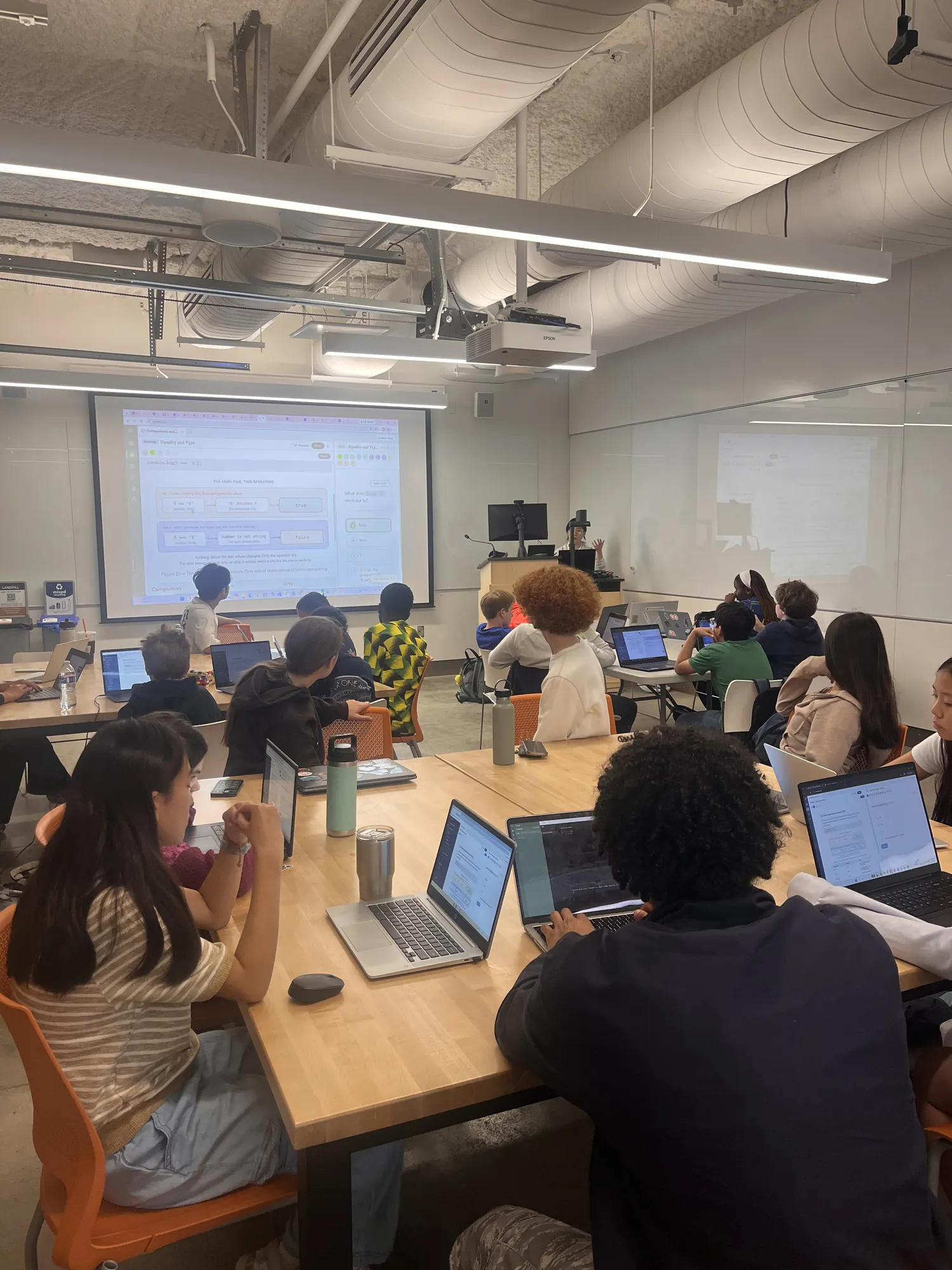 A room of students working at tables during a CurioLab session